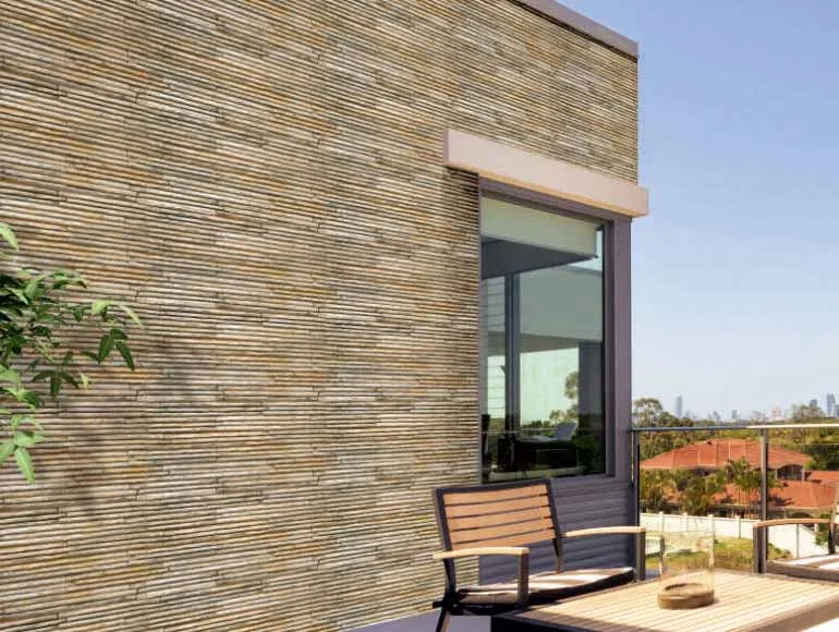 Front elevation design showcasing a modern patio with stone wall, glass railing, and city skyline.